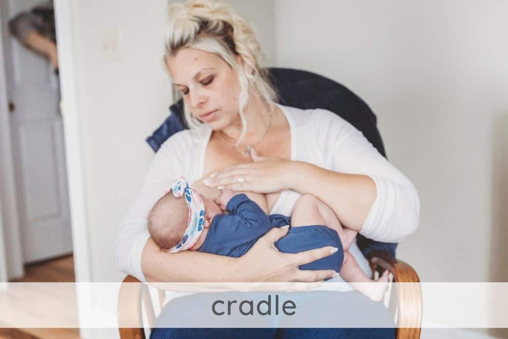 Woman using cradle breastfeeding position in rocking chair