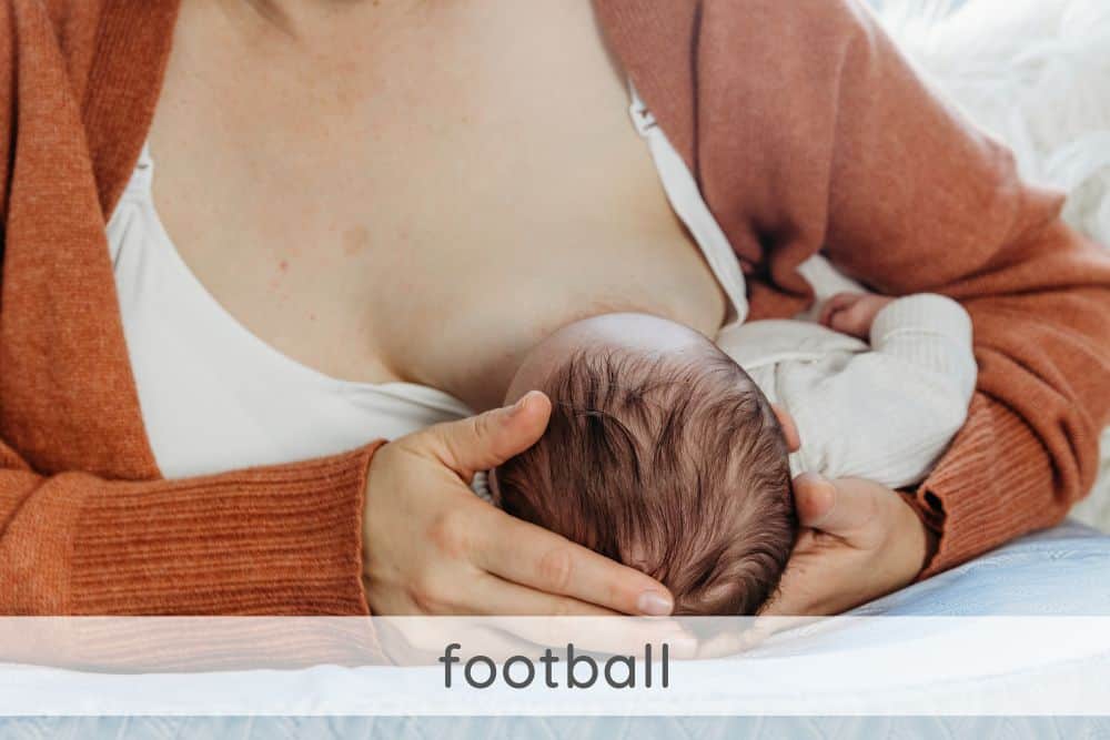 Newborn in football feeding position