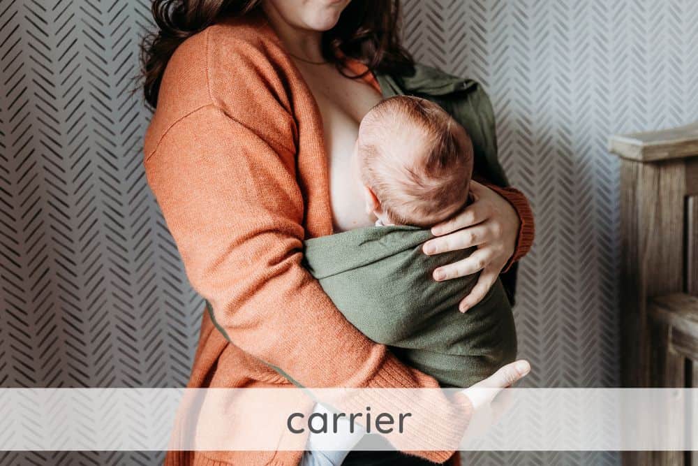 Parent feeding baby in a sling or carrier