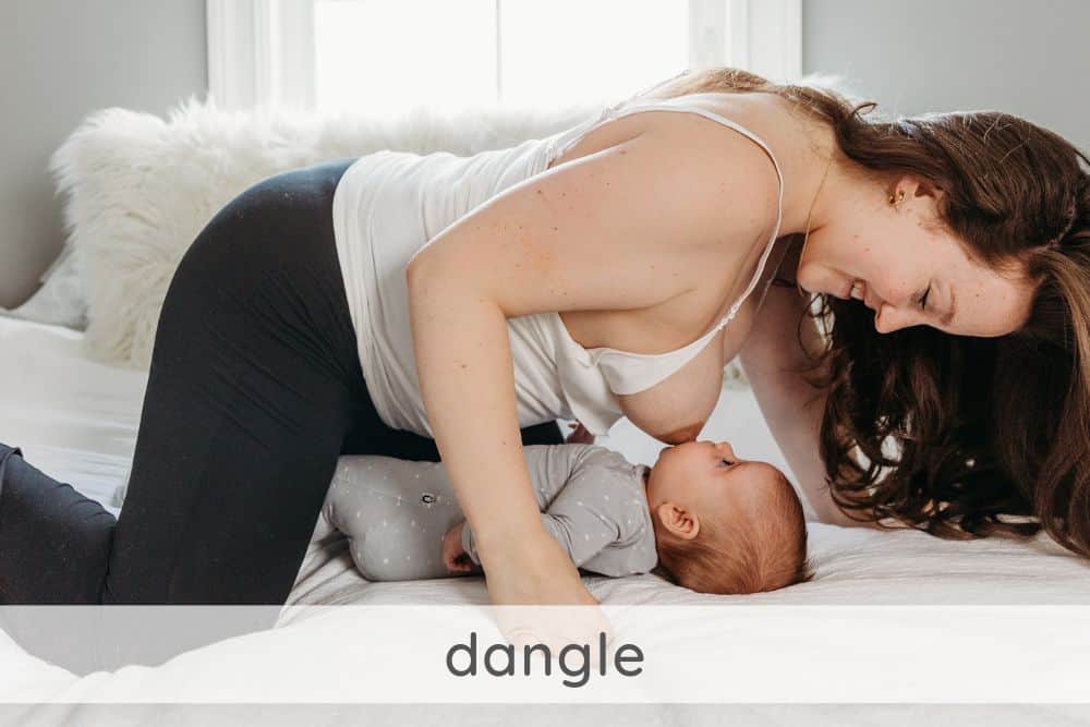 Feeding baby in a dangle position on bed