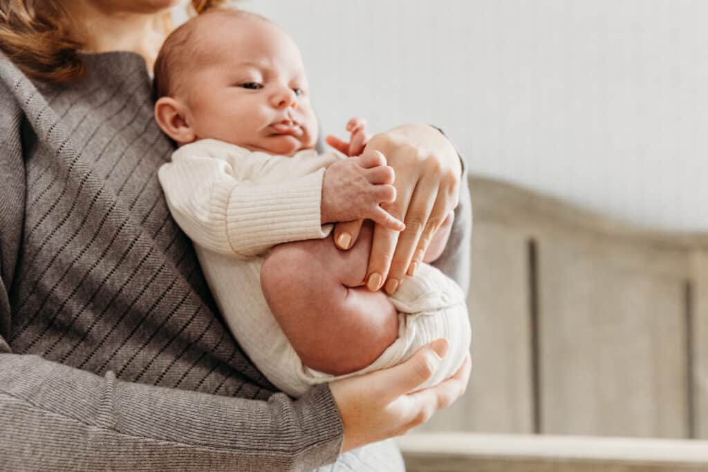 newborn in position with legs up to relieve gas